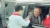 FILE - Soviet General Secretary Mikhail Gorbachev leans out of the window of his limousine to shake the hand of a Chinese child on hand to greet him as he arrived at Shanghai Airport on May 19, 1989, in Shanghai, China.