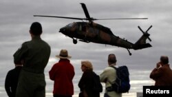 FILE - Spectators watch as a Sikorsky UH-60 Black Hawk helicopter belonging to the Australian Army conducts an exercise during the Australian International Airshow in Melbourne, March 2, 2011.