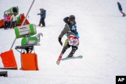 Sekholo Ramonotsi, 13, competes in the Winter Whip Slopestyle snowboard and ski competition at the Afriski ski resort near Butha-Buthe, Lesotho, Saturday July 30, 2022. (AP Photo/Jerome Delay)