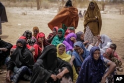 Villagers gather during a visit by World Food Program chief David Beasley, in the village of Wagalla in northern Kenya Friday, Aug. 19, 2022. (AP Photo/Brian Inganga)