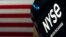 FILE - An NYSE sign is seen on the floor at the New York Stock Exchange in New York, June 15, 2022. 