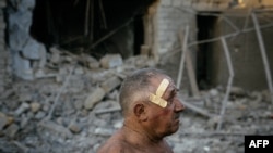 29일 우크라이나 남부 헤르손 인근 므콜라이우 시내에서 러시아군 공격으로 파괴된 주택을 주민이 살펴보고 있다. 