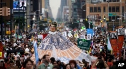 FILE - People fill the street during the People's Climate March in New York, Sept. 21, 2014.