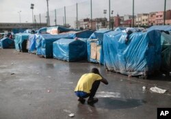A sub-Saharan migrant washes at Ouled Ziane camp in Casablanca, Morocco, Dec. 6, 2018.