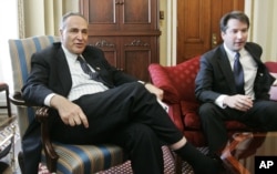 FILE - Sen. Charles Schumer, D-N.Y., meets with Brett Kavanaugh, right, then-nominee for the D.C. Circuit Court, on Capitol Hill, May 2, 2006.