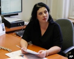 Prague's Municipal Court's spokeswoman Marketa Puci, holds a copy of the official verdict sentencing George Nader to a one-year prison term, at her office in Prague, Czech Republic, March 14, 2018.