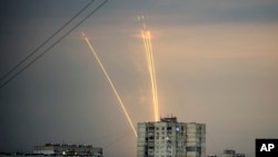 Russian rockets launch against Ukraine from Russia's Belgorod region are seen at dawn in Kharkiv, Ukraine, Aug. 15, 2022. 