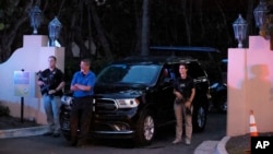 Armed Secret Service agents stand outside an entrance to former President Donald Trump's Mar-a-Lago estate, Aug. 8, 2022, in Palm Beach, Florida. 
