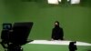 FILE - Masheed Barzz, an Afghan presenter for 1TV channel, appears on camera with her face covered by a veil in Kabul on May 25, 2022. Female journalists are banned from state-run media outlets, and those in the private sector can appear on TV only if their faces are covered. 