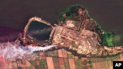 This composite of satellite images taken by Planet Labs PBC shows smoke rising from fires at the Zaporizhzhia nuclear power plant in southeastern Ukraine, Aug. 24, 2022. A team from the U.N.'s International Atomic Energy Agency is expected to visit the Russian-occupied plant soon but more shelling was reported in the area overnight on Aug. 26, 2022.