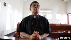 FILE - Rolando Alvarez, bishop of the Diocese of Matagalpa and Esteli and critical of the Nicaraguan President Daniel Ortega, prays at a Catholic church where he was taking refuge prior to his imprisonment, in Managua, Nicaragua, May 20, 2022.