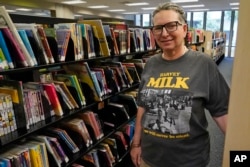 Gretchen Robinson, a lesbian high school teacher in Orange County, Fla., poses for a photo at the downtown library, Saturday, Aug. 13, 2022, in Orlando, Fla. (AP Photo/John Raoux)