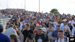 Spectators leave the Max Brewer Bridge after a scrub of the launch of the Artemis I mission to orbit the moon at the Kennedy Space Center, Aug. 29, 2022, in Titusville, Fla.