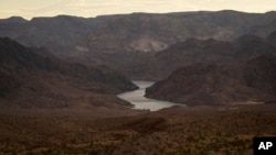Water flows down the Colorado River from the Hoover Dam in northwest Arizona, Aug. 14, 2022.