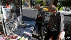 People scan publications at a news stand in Tehran, Iran, Aug. 13, 2022.