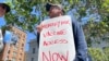 FILE - A man holds a sign urging increased access to the monkeypox vaccine during a protest in San Francisco, July 18, 2022. 
