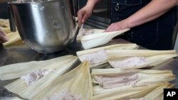Jessica Pamonicutt, executive chef of a Native American catering company in Chicago, serves roasted turkey tamales, part of a contemporary Indigenous meal she cooked for Elders at the American Indian Center of Chicago, on Aug. 3, 2022.