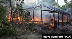A village hut burns to the ground in Rakhine in September 2017.