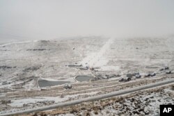 Fresh snow covers the Afriski ski resort near Butha-Buthe, Lesotho, Saturday July 30, 2022. (AP Photo/Jerome Delay)