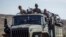FILE - Ethiopian government soldiers ride in the back of a truck on a road near Agula, north of Mekelle, in the Tigray region of northern Ethiopia, May 8, 2021.