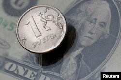 FILE PHOTO: A view shows a Russian rouble coin and a U.S. dollar banknote in this picture illustration taken October 26, 2018. REUTERS/Maxim Shemetov/File Photo