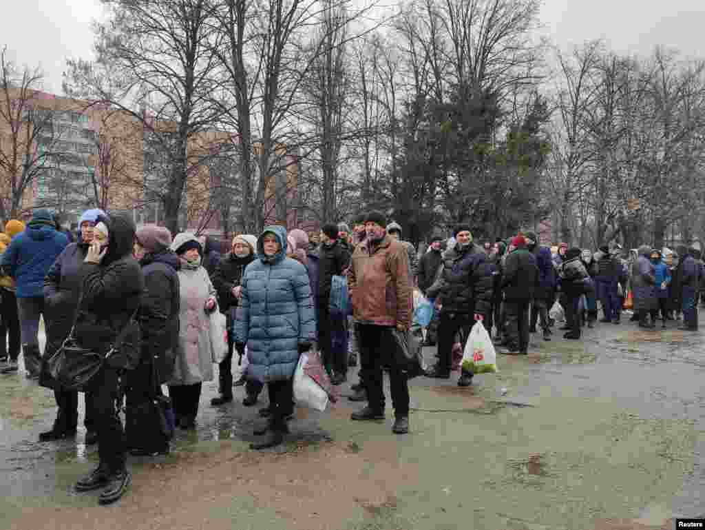 Local residents queue to receive food at a hospital in Kharkiv as Russia&#39;s invasion of Ukraine continues, March 2, 2022.