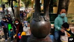 Children accompanied by their parents line up to receive China's Sinovac COVID-19 coronavirus vaccine at a community vaccination center in Hong Kong, Feb. 25, 2022. 