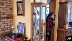 Mary Risling stands near a photo of her missing sister, Emmilee Risling, at the family home on Jan. 21, 2022, in McKinleyville, California.