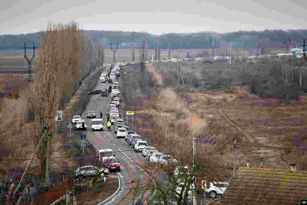 Cars wait to pick up family members and refugees fleeing the war in Ukraine, in Palanca, Moldova, March 2, 2022. 