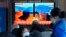 People watch a TV showing a file image of North Korea's missile launch during a news program at the Seoul Railway Station in Seoul, South Korea, Feb. 27, 2022. 