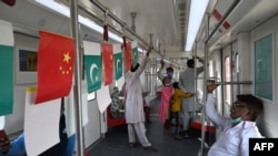 FILE - Passengers ride in an Orange Line Metro Train, a metro project planned under the China-Pakistan Economic Corridor, a day after an official opening in the eastern city of Lahore, Pakistan, Oct. 26, 2020.
