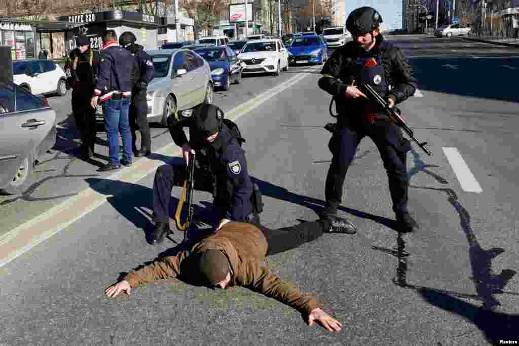 Police officers check people from a suspicious car they stopped, as Russia&#39;s invasion of Ukraine continues, in Kyiv, Ukrain, Feb. 28, 2022. 
