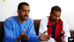 FILE - In this March 30, 2018, photo, Alexanda Kotey, left, and El Shafee Elsheikh, who were allegedly among four British jihadis who made up a brutal Islamic State cell dubbed "The Beatles," speak in Kobani, Syria. 