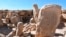 This photo provided by Jordan's Tourism Ministry shows two carved standing stones at a remote Neolithic site in the country’s eastern desert. 