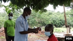 A villager in Southern Malawi readying for a COVID-19 jab. (Lameck Masina/VOA)