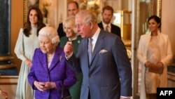 Britain's Prince Charles, Prince of Wales (C) walks with his mother Britain's Queen Elizabeth II (2L), and his wife Britain's Camilla, Duchess of Cornwall (3L), and his sons and their wives, Britain's Prince William, Duke of Cambridge (4L) and Britain's C
