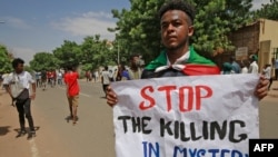 Sudanese protesters shout slogans outside the Council of Ministers in the heart of Sudan's capital Khartoum, Aug. 17, 2020.