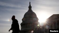 A visitor walks by the U.S. Capitol during a partial government shutdown in Washington, Jan. 22, 2019.
