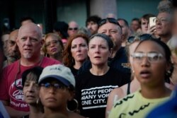 Mourners attend a vigil at the scene after a mass shooting in Dayton, Ohio, Aug. 4, 2019