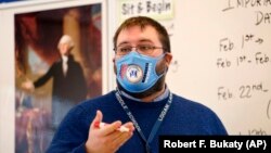 Logan Landry speaks to his class at the Bruce M. Whittier Middle School in Maine, Jan. 29, 2021. Many of the nation's teachers have given up on covering all the material normally included in their classes and instead are cutting lessons. (AP Photo/Robert F. Bukaty)