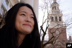 Julia Riew poses outside Lowell House, on the campus of Harvard University in Cambridge, Mass., Feb. 16, 2022.