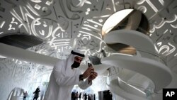 A man take a photo at the Museum of the Future, an exhibition space for innovative and futuristic ideas in Dubai, United Arab Emirates, Wednesday, Feb. 23, 2022. (AP Photo/Kamran Jebreili)