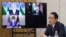 This picture taken March 3, 2022, shows Japanese Prime Minister Fumio Kishida attending the Quadrilateral Security Dialogue online meeting in Tokyo, with (on screen) Indian Prime Minister Narendra Modi, U.S. President Joe Biden and Australia's Prime Minister Scott Morrison. 