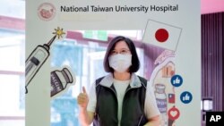 In this photo released by the Taiwan Presidential Office, Taiwanese President Tsai Ing-wen poses for a photo after receiving her intital shot of the island's first domestically developed coronavirus vaccine, Aug. 23, 2021.
