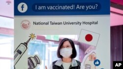 In this photo released by the Taiwan Presidential Office, Taiwanese President Tsai Ing-wen poses for a photo after receiving her intital shot of the island's first domestically developed coronavirus vaccine, Aug. 23, 2021.