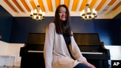 Julia Riew poses at Farkus Hall, on the campus of Harvard University in Cambridge, Mass., Feb. 16, 2022. 