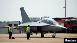 Pilots operate a JL-10 advance trainer jet of Chinese People's Liberation Army (PLA) Air Force at the China International Aviation and Aerospace Exhibition, or Airshow China, in Zhuhai, Guangdong province, China September 28, 2021. REUTERS/Aly Song