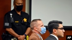 Former Louisville Police officer Brett Hankison, center, awaits the juries verdict in his wanton endangerment trial, in Louisville, Ky., March 3, 2022.