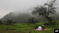 Three Omani men play the card game "Uno" under the foggy weather of southern Oman's summer monsoon in the Jabal Ayoub mountains north of Salalah on Wed. August 2, 2017. (AP Photo/Sam McNeil)