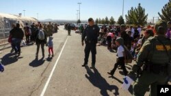 FILE - This May 29, 2019 photo released by U.S. Customs and Border Protection (CBP) shows some of 1,036 migrants who crossed the U.S.-Mexico border in El Paso, Texas, the largest that the Border Patrol says it has ever encountered.